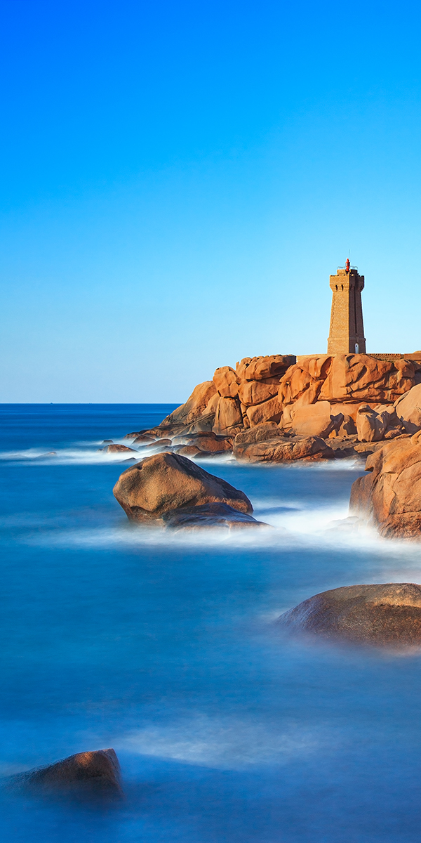 Ploumanach lighthouse sunset in pink granite coast, Brittany, France