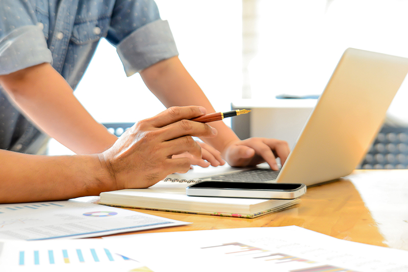 Two people working at a computer