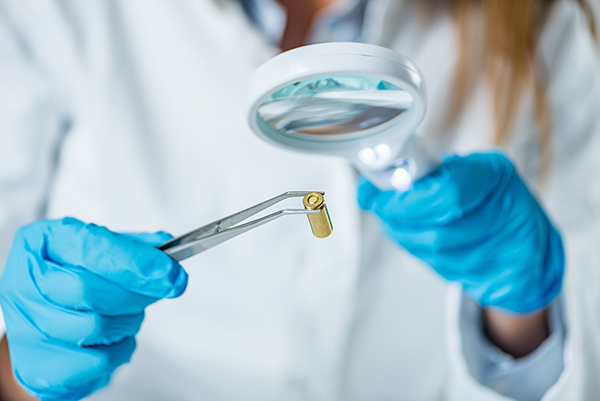 forensic scientist examining bullet casing