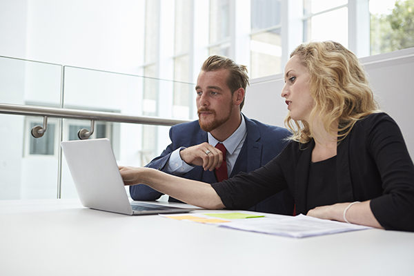 two business people using a laptop