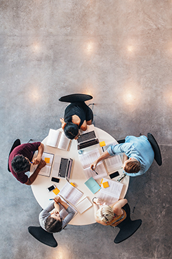 Group of researchers sitting around a table