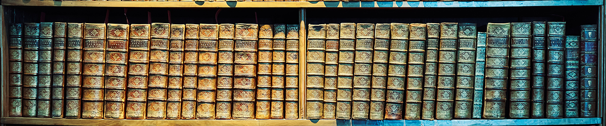 Vintage toned old books on wooden shelves